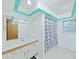Bathroom featuring a shower/tub combo with blue shower curtain and a light bright vanity at 13094 Huntington Woods Ave, Spring Hill, FL 34609