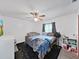 Cozy bedroom with a ceiling fan and a crib, perfect for a Gathering with a young  at 13094 Huntington Woods Ave, Spring Hill, FL 34609