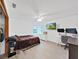 Bright bedroom with hard surface floors, ceiling fan, and a dedicated desk area at 13094 Huntington Woods Ave, Spring Hill, FL 34609
