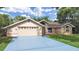Charming single-story home with a two-car garage and well-maintained lawn at 13094 Huntington Woods Ave, Spring Hill, FL 34609
