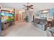 Open-concept living room with ample seating, a large television, and easy access to dining area at 13094 Huntington Woods Ave, Spring Hill, FL 34609