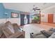 Comfortable living room featuring a modern ceiling fan, a large window, and neutral walls at 13094 Huntington Woods Ave, Spring Hill, FL 34609