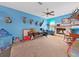 Eclectic living room with stone fireplace, ceiling fan, and collection of animal mounts at 13094 Huntington Woods Ave, Spring Hill, FL 34609