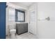 Modern bathroom featuring a sleek vanity, decorative mirror, and tiled floors at 13377 Elise Ln, Spring Hill, FL 34609