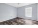 Bright bedroom features wood flooring and a window letting in plenty of natural light at 13377 Elise Ln, Spring Hill, FL 34609