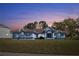 Inviting single-story home with well-manicured lawn, attractive architectural details, and blue accents at 13377 Elise Ln, Spring Hill, FL 34609