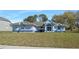 Charming single-story home with a well-maintained lawn, blue accents, and inviting curb appeal at 13377 Elise Ln, Spring Hill, FL 34609