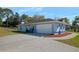 Spacious garage with ample parking space and a long driveway, surrounded by mature trees at 13377 Elise Ln, Spring Hill, FL 34609