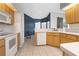Functional kitchen with white appliances, light wood cabinets, and a cozy breakfast nook at 13377 Elise Ln, Spring Hill, FL 34609
