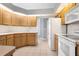 Bright kitchen features white appliances, light wood cabinets, and a tile backsplash at 13377 Elise Ln, Spring Hill, FL 34609
