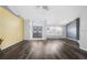 Open-concept living area with wood-look floors, gray accent walls, and an inviting entryway at 13377 Elise Ln, Spring Hill, FL 34609