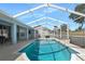 Inviting in-ground screened pool, with a patio area, perfect for relaxation and entertaining at 13377 Elise Ln, Spring Hill, FL 34609
