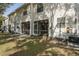 View of the townhouse backyard featuring a screened patio and green space at 13521 Forest Lake Dr, Largo, FL 33771