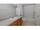 Functional bathroom with vanity, built-in shelving, and shower-tub combination at 13521 Forest Lake Dr, Largo, FL 33771