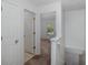 Bright hallway with white walls leading to a bedroom with natural light at 13521 Forest Lake Dr, Largo, FL 33771