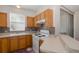 Charming kitchen with light wood cabinetry, white appliances, and a convenient breakfast bar at 13521 Forest Lake Dr, Largo, FL 33771