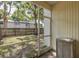 Enclosed patio offers a private outdoor space with a view of the backyard and surrounding greenery at 13521 Forest Lake Dr, Largo, FL 33771