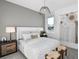 Cozy bedroom featuring a comfortable bed, stylish lamps, and decorative wall art at 1576 Valier Pt, Zephyrhills, FL 33541