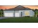 Charming single-story home with a three-car garage, well-manicured lawn, and beautiful landscaping at 1576 Valier Pt, Zephyrhills, FL 33541
