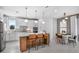 Modern kitchen with white cabinets, stainless steel appliances, breakfast bar, and adjacent dining area at 1576 Valier Pt, Zephyrhills, FL 33541
