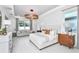 Serene main bedroom with a tray ceiling, modern lighting, and large windows overlooking the yard at 1576 Valier Pt, Zephyrhills, FL 33541