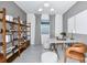 Stylish office space featuring wood shelving, modern desk, ample light, and comfortable seating at 1576 Valier Pt, Zephyrhills, FL 33541