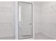 Spacious walk-in closet with ample shelving and a view into the attached bathroom at 1576 Valier Pt, Zephyrhills, FL 33541