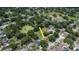 Aerial shot of a home, highlighting its large lot and nearby green spaces, including a pond and park at 1617 Dawnridge Ct, Brandon, FL 33510