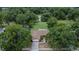 Overhead shot of a house with a driveway, mature trees, and manicured landscaping at 1617 Dawnridge Ct, Brandon, FL 33510