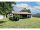 View of the home's back exterior, highlighting the enclosed patio and well-kept lawn at 1617 Dawnridge Ct, Brandon, FL 33510