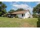 Home exterior with screened lanai and lush green yard under a bright sky at 1617 Dawnridge Ct, Brandon, FL 33510