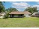 Exterior shot showcasing a house with a screened patio and well-maintained backyard at 1617 Dawnridge Ct, Brandon, FL 33510