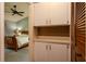 View into the bedroom with a ceiling fan and an attached area featuring built in storage at 1617 Dawnridge Ct, Brandon, FL 33510
