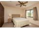 Bedroom with a ceiling fan, carpeted floors, and a window with outdoor views at 1617 Dawnridge Ct, Brandon, FL 33510
