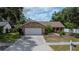 Charming single-story home featuring a two-car garage and mature landscaping, enhancing its curb appeal at 1617 Dawnridge Ct, Brandon, FL 33510