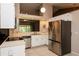 Bright kitchen with stainless steel appliances, white cabinetry, and a functional layout for cooking and entertaining at 1617 Dawnridge Ct, Brandon, FL 33510