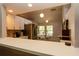 Open-concept kitchen featuring stainless steel appliances, white cabinets, and a breakfast bar for casual dining at 1617 Dawnridge Ct, Brandon, FL 33510