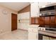 Efficient kitchen design with white cabinets, stainless steel appliances, and a cozy layout at 1617 Dawnridge Ct, Brandon, FL 33510