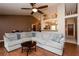 Open-concept living room featuring a cozy gray sectional couch and breakfast bar to the kitchen at 1617 Dawnridge Ct, Brandon, FL 33510