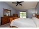 Spacious main bedroom with vaulted ceiling, ceiling fan, and a large wood dresser at 1617 Dawnridge Ct, Brandon, FL 33510