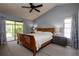 Main bedroom with vaulted ceiling, ceiling fan, and door to screened porch at 1617 Dawnridge Ct, Brandon, FL 33510