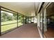 A large screened patio with a carpeted floor overlooking a green lawn and mature trees at 1617 Dawnridge Ct, Brandon, FL 33510