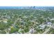 This aerial view showcases a neighborhood near the coast and skyline featuring lush green trees at 1620 15Th N St, St Petersburg, FL 33704