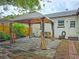 Landscaped backyard with a brick patio, outdoor gazebo, and a cozy seating area at 1620 15Th N St, St Petersburg, FL 33704