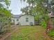 Spacious backyard featuring a brick walkway, mature trees, and a well maintained lawn at 1620 15Th N St, St Petersburg, FL 33704