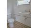 Simple bathroom with a white toilet, sink, and a window, providing essential functionality at 1620 15Th N St, St Petersburg, FL 33704