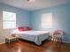 Bright bedroom with hardwood floors, two windows, and a seating area at 1620 15Th N St, St Petersburg, FL 33704