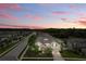 Beautiful home with manicured lawn in quiet neighborhood under a vibrant sunset sky at 18696 Malinche Loop, Spring Hill, FL 34610