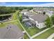 View of the property and screen enclosed pool amidst a neighborhood with ponds and tree coverage at 18696 Malinche Loop, Spring Hill, FL 34610