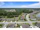 Picture of a lovely neighborhood with manicured lawns, tree lined streets, and community pond at 18696 Malinche Loop, Spring Hill, FL 34610